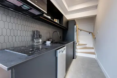 a kitchen with a sink and a counter top at Le Mile End by M11 - 2 BDR Loft with Sofa Bed in Montréal