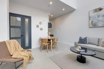a living room with a couch and a table at Le Mile End by M11 - 2 BDR Loft with Sofa Bed in Montréal
