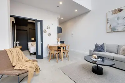 a living room with a couch and a table at Le Mile End by M11 - 2 BDR Loft with Sofa Bed in Montréal