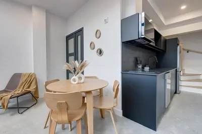 a small kitchen and dining room with a table and chairs at Le Mile End by M11 - 2 BDR Loft with Sofa Bed in Montréal