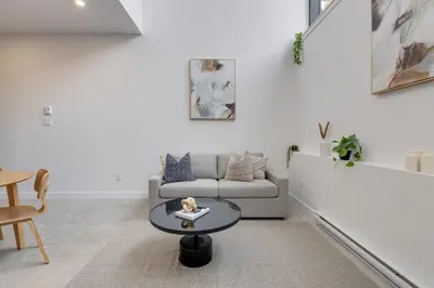 a living room with a couch and a table at Le Mile End by M11 - 2 BDR Loft with Sofa Bed in Montréal