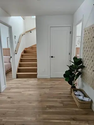 a hallway with a staircase and a potted plant in a room at Chalet Le Hygge Hytte - Ski - Golf - Spa in Thetford Mines