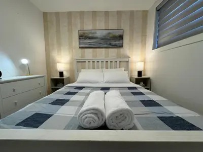 a bedroom with a bed with towels on it at Le Rêve Montréal! New & Modern! Easy Access Downtown & Attractions! in Montréal