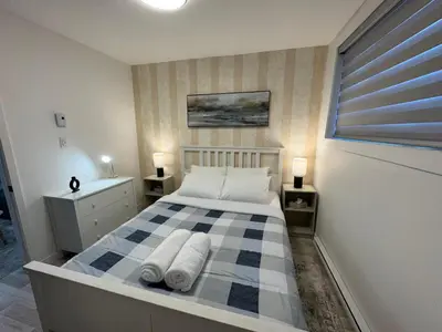 a bedroom with a bed with towels on it at Le Rêve Montréal! New & Modern! Easy Access Downtown & Attractions! in Montréal