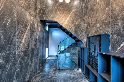 a staircase in a building with a marble wall at Le Rêve Montréal! New & Modern! Easy Access Downtown & Attractions! in Montréal
