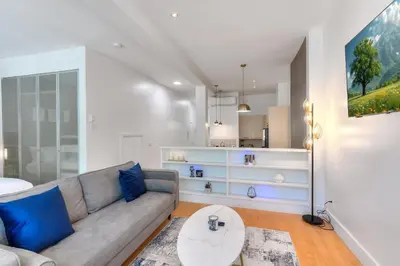 a living room with a couch and a table at Take a break in a modern loft on Plateau-Mont-Royal in Montréal