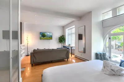 a bedroom with a bed and a couch at Take a break in a modern loft on Plateau-Mont-Royal in Montréal