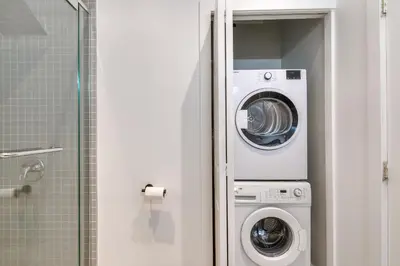 a washer and dryer in a bathroom next to a shower at Take a break in a modern loft on Plateau-Mont-Royal in Montréal