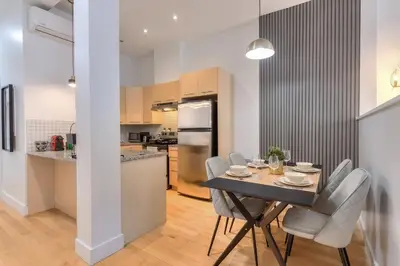 a kitchen and dining room with a table and chairs at Take a break in a modern loft on Plateau-Mont-Royal in Montréal