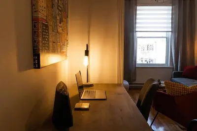 a dining room table with a laptop computer on it at Appartement au coeur de Villeray in Montréal