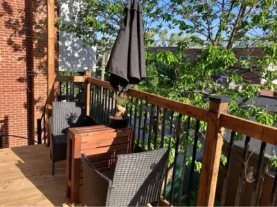 an umbrella sitting on top of a wooden deck at Appartement au coeur de Villeray in Montréal