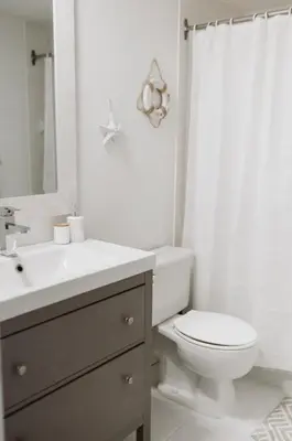 a white bathroom with a toilet and a sink at Etoile bleue Beach bike shops Magog-Orford in Magog-Orford