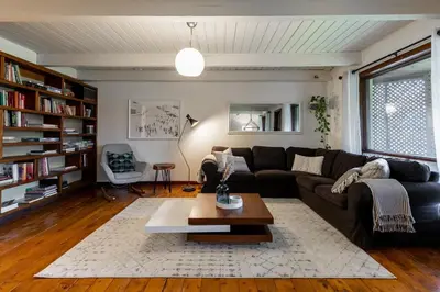 a living room with a couch and a coffee table at L'Orford VIEW POOL TENNIS SPA in Orford
