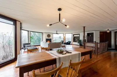 a living room with a table and chairs at L'Orford VIEW POOL TENNIS SPA in Orford