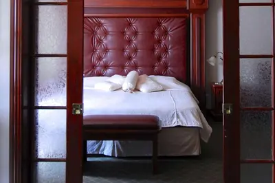 a bed with a red headboard and two pillows on it at Hôtel Travelodge by Wyndham Victoriaville in Victoriaville