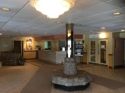 a waiting room with a chair in a lobby at Hôtel Travelodge by Wyndham Victoriaville in Victoriaville