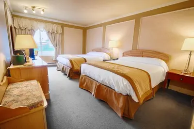 a hotel room with two beds and a window at Hôtel Travelodge by Wyndham Victoriaville in Victoriaville
