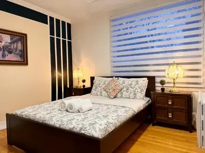 a bedroom with a bed with two towels on it at Relaxation Retreat Unit in Montréal