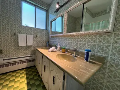 a bathroom with a sink and a mirror at Relaxation Retreat Unit in Montréal
