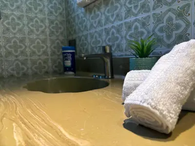 a bathroom sink with two towels on a counter at Relaxation Retreat Unit in Montréal