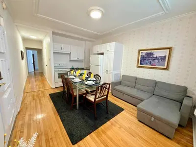 a living room with a couch and a table with chairs at Relaxation Retreat Unit in Montréal