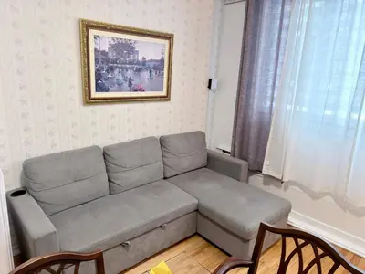 a couch in a living room with a picture on the wall at Relaxation Retreat Unit in Montréal