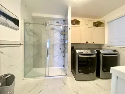 a bathroom with a walk in shower and a dishwasher at Feels like a Home ,Away from Home ! in Montréal