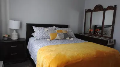a bedroom with a bed with a yellow blanket at Feels like a Home ,Away from Home ! in Montréal
