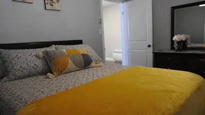 a bedroom with a bed with a yellow blanket at Feels like a Home ,Away from Home ! in Montréal
