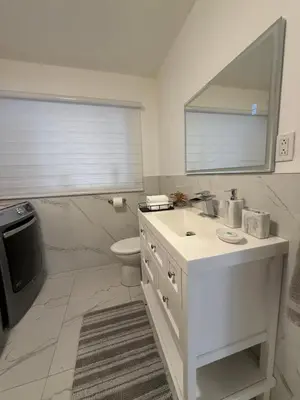 a white bathroom with a sink and a toilet at Feels like a Home ,Away from Home ! in Montréal