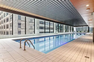 an indoor swimming pool in a building with a building at Sky Bridge Spectacular in Montréal