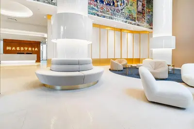 a lobby with white chairs and a large sculpture at Sky Bridge Spectacular in Montréal