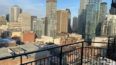 a view of a city skyline from a balcony at Downtown Central Residences in Montréal