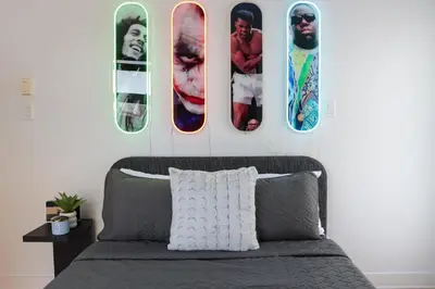 a bedroom with a bed with four pictures on the wall at Luxury Artist Condo In Montreal in Montréal