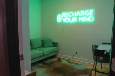 a living room with a couch and a neon sign at Luxury Artist Condo In Montreal in Montréal
