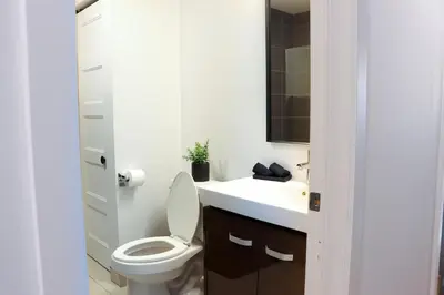 a bathroom with a toilet and a sink at Luxury Artist Condo In Montreal in Montréal