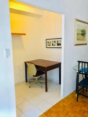 a desk and a chair in a room at Stylish Montreal Apartment Comfortable Stay in the Golden Square Mile in Montréal