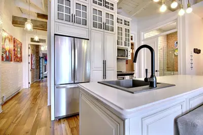 a kitchen with a sink and a refrigerator at Galeria St Denis in Prime Montreal in Montréal