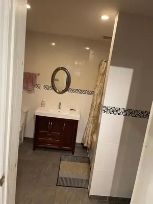 a bathroom with a sink and a mirror at Self service small breakfast, 2 double beds private room in Montréal