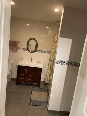 a bathroom with a sink and a mirror at Self service small breakfast, 2 double beds private room in Montréal