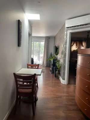 a dining room with a table and chairs in a room at Self service small breakfast, 2 double beds private room in Montréal