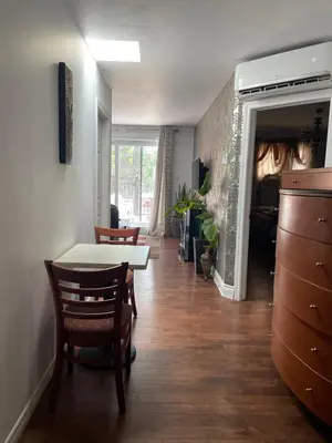 a living room with a table and chairs and a dining room at Self service small breakfast, 2 double beds private room in Montréal