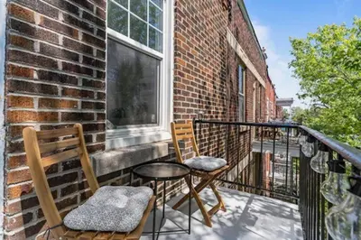 a balcony with two chairs and a table and a window at Appartement haut de gamme NDG in Montréal