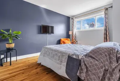 a bedroom with a bed and a window at Cozy 3 Bedrooms Montreal in Montréal