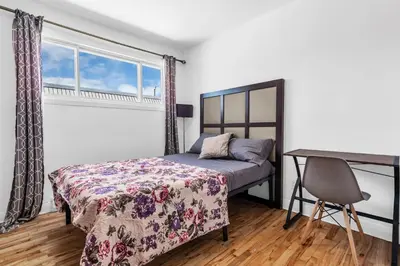 a bedroom with a bed and a desk at Cozy 3 Bedrooms Montreal in Montréal