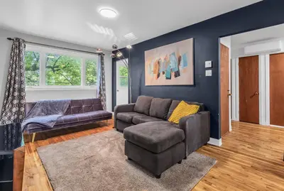 a living room with a couch and a chair at Cozy 3 Bedrooms Montreal in Montréal
