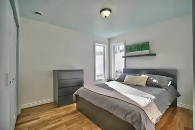 a bedroom with a large bed and a window at Dynamite 2-Bedroom House, Garage, Sleeps 6 in Sherbrooke