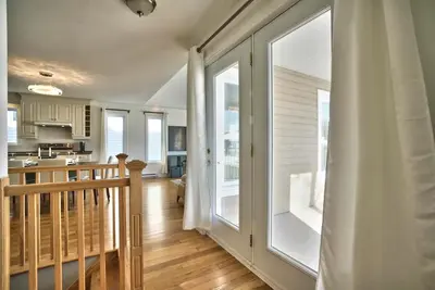 a kitchen and living room with a large window at Dynamite 2-Bedroom House, Garage, Sleeps 6 in Sherbrooke