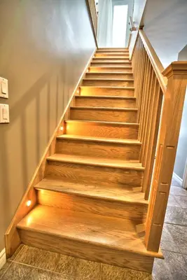 a stairway with wooden steps in a house at Dynamite 2-Bedroom House, Garage, Sleeps 6 in Sherbrooke
