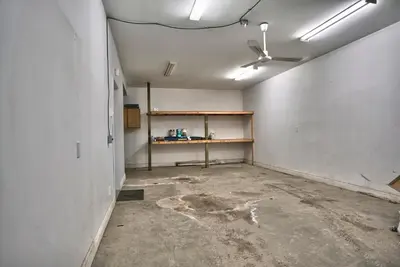 an empty room with a ceiling fan and a shelf at Dynamite 2-Bedroom House, Garage, Sleeps 6 in Sherbrooke